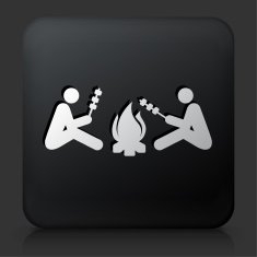 Black Square Button with Two People Next to Campfire