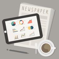 tablet and newspaper with coffee