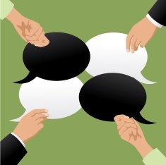 Four hands holding black and white speech bubbles