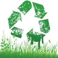 Recycling sign on grass background