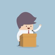 Businessman standing on podium and giving a speech