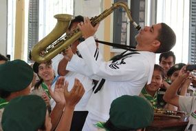 student sailor playing the saxophone