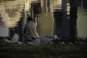 old man philosopher on river coast