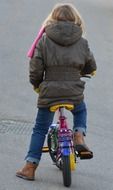 girl on small bicycle