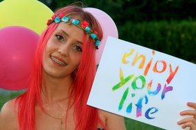 girl with pink hair on the background of balloons