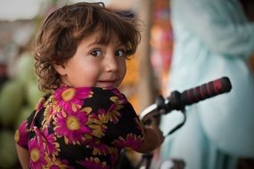 young girl sitting on a bike