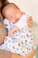 newborn baby in mother's arms