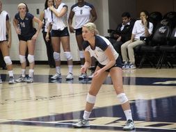 blonde girl playing volleyball