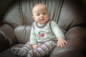baby on the leather armchair