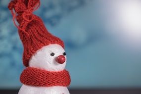 snow man in red winter clothes