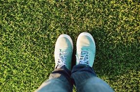 feet on a green lawn