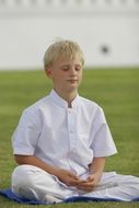 boy buddhist on green grass