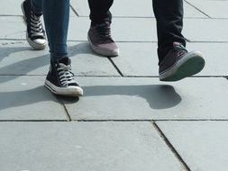 photo of the legs of walking teenagers