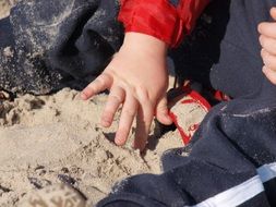 baby playing in the sand