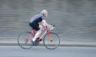 man rides a bicycle on the road