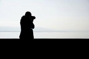 silhouette of photographer with camera