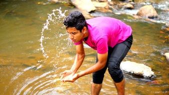 young man in spray of water