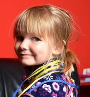 blonde girl with a serpentine on her shoulders at a holiday