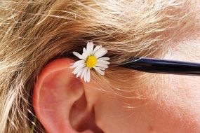 little daisy behind the blonde's ear