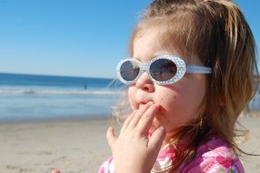 girl in glasses on the background of the sea