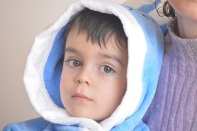 portrait dark haired boy in blue