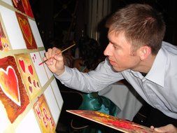 the artist paints heart