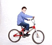 photo of a boy on a red bike