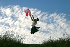 girl with balls jumps on the field