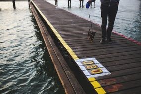 man with dog on the pier