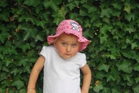 little girl in summer hat with hello kitty