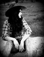 Black and white image of a girl in the style of the wild west