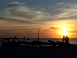 silhouettes of people on a sunset background