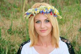 portrait of a nice blonde girl with a wreath