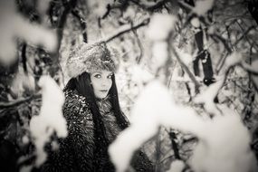 black and white portrait of a woman in winter forest
