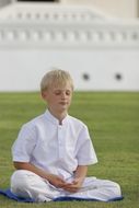 teen meditating on the background of buddhism temple in Thailand