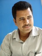 black and white photo of a man with a pensive face on a blue background