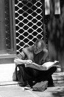 man read on street
