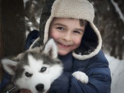 photo of a boy with husky