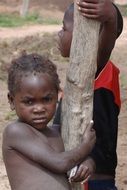 black child near a tree