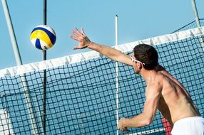 ball near a network in beach volleyball