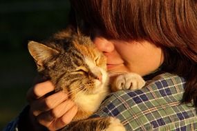 child with cat on shoulder