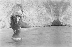 Black and white image of a girl in a swimsuit on vacation