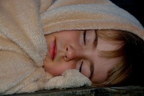 sleeping child in blanket