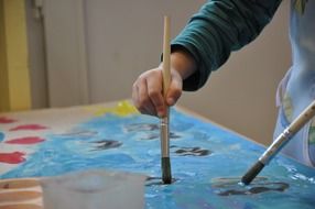 child drawing with a brush