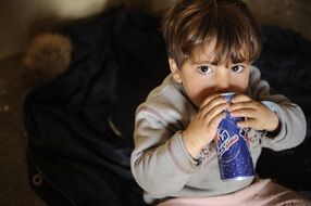 child is drinking lemonade