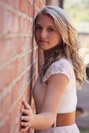 beautiful girl near a brick wall