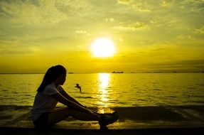 girl is resting on the background of the sunrise