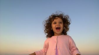 Happy lauthing curly haired girl