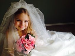 Child dressed up in the wedding dress