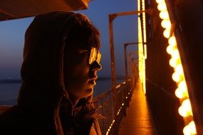 man on the illuminated bridge at night